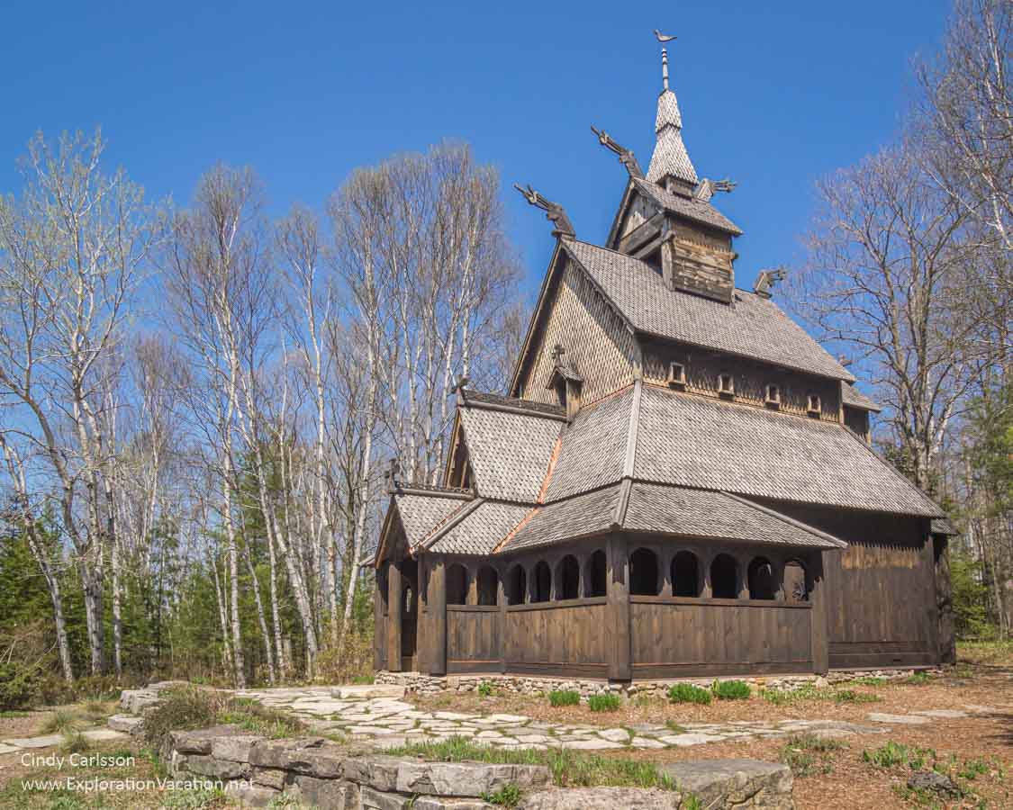 exterior of a stave church in a woodland