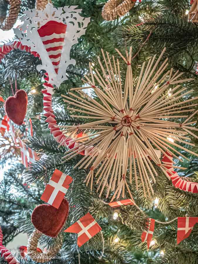 Straw and paper Danish Christmas decorations on a tree.