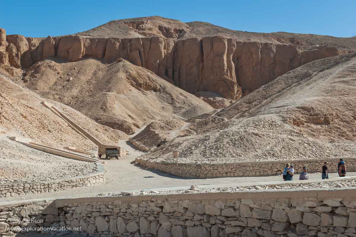 rugged hills with walled road and entrance to tombs