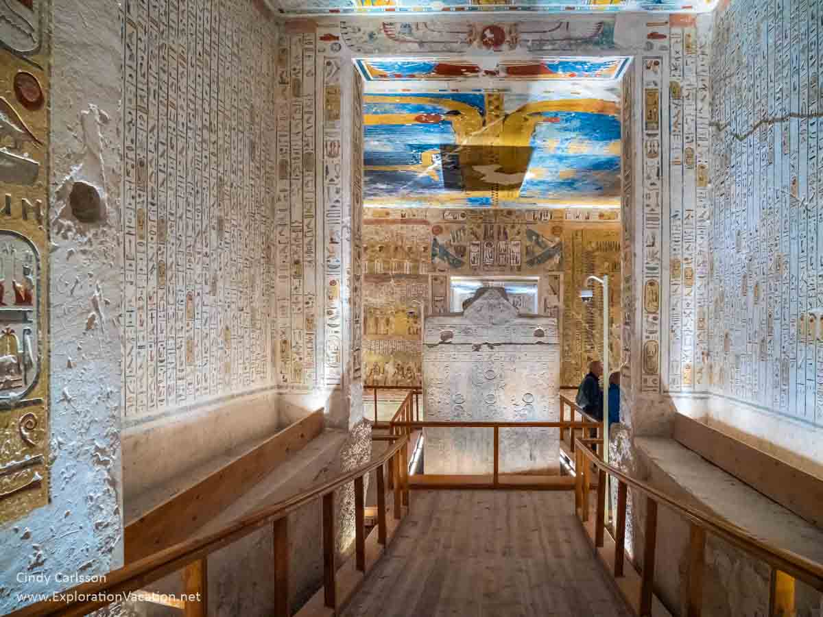 brightly painted white walls in a tomb with a large sarcophagus