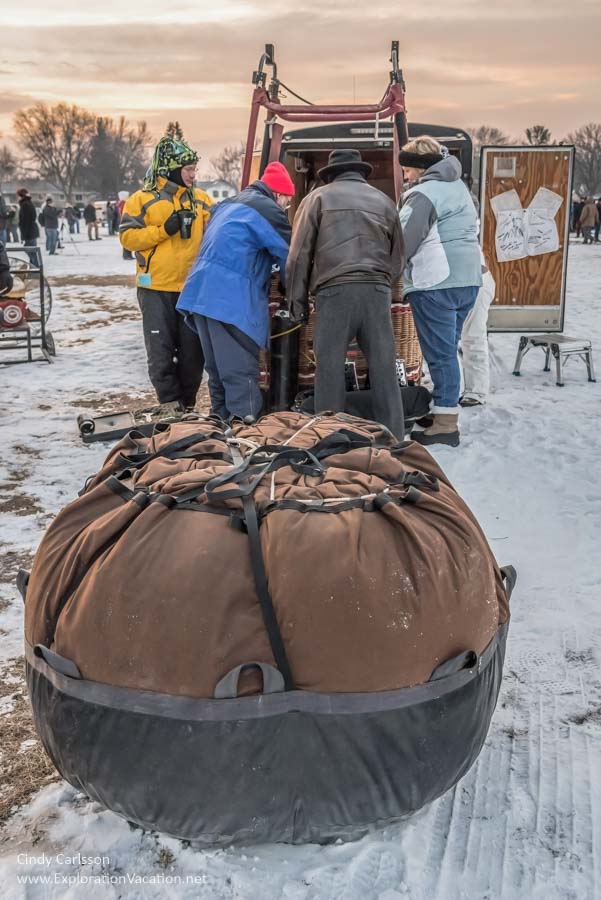 Photo of a big round bundle with a group of people working in the background at the Hudson Hot Air Affair in Wisconsin. (Photo &copy; Cindy Carlsson on ExplorationVacation.net)