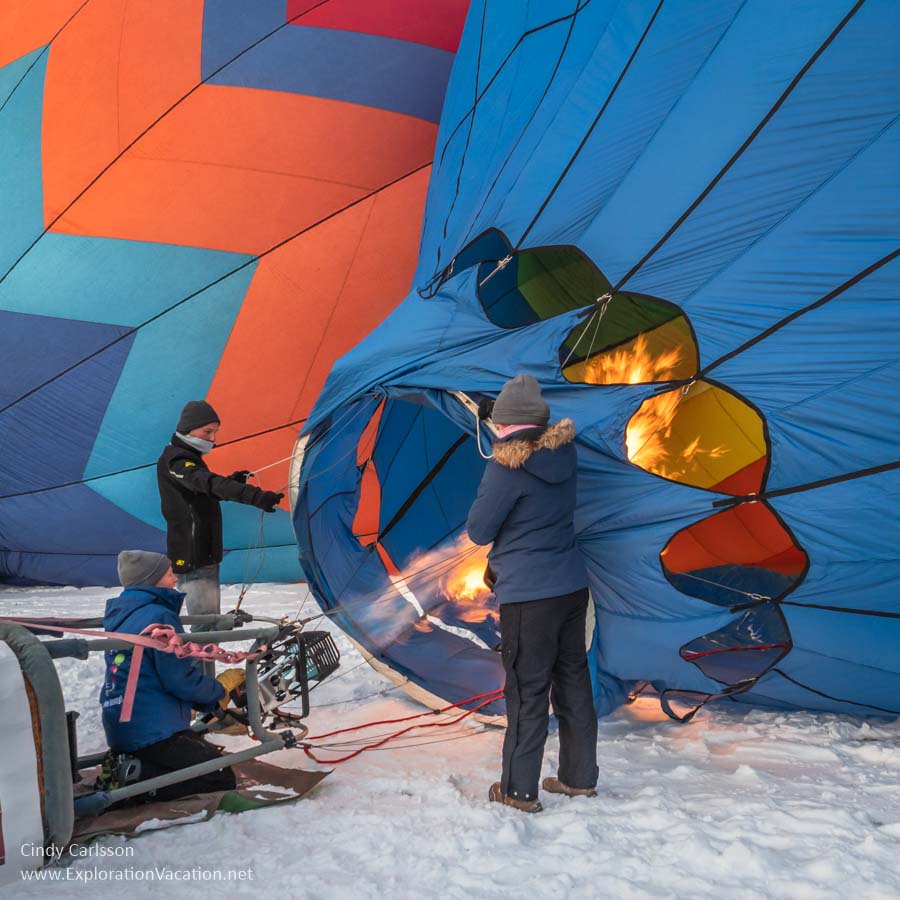 Photo of people holding a balloon as burners shoot flames into it at the Hudson Hot Air Affair in Wisconsin. (Photo &copy; Cindy Carlsson on ExplorationVacation.net)