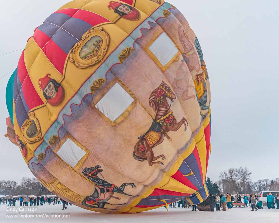 an old-fashioned hand-painted balloon begins to lift from the ground