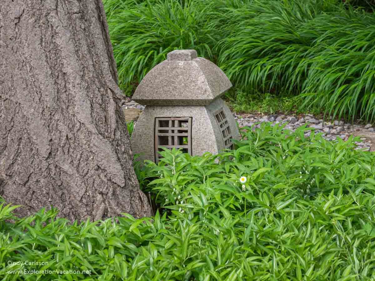 stone Japanese lantern at the base of a tree