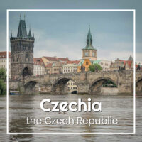 Stone bridge and towers in Prague with text "Czechia - the Czech Republic"