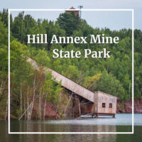 mining elevator above water with text "Hill Annex Mine State Park"