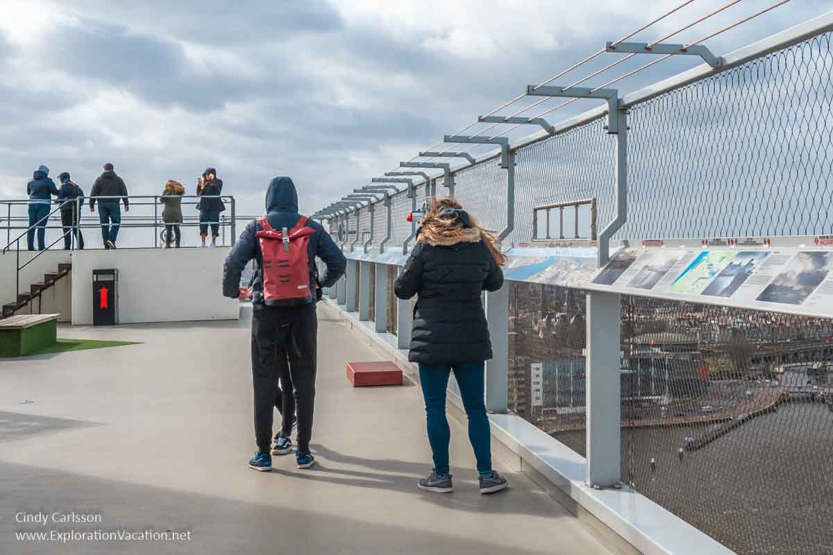 people standing on a large deck with fencing
