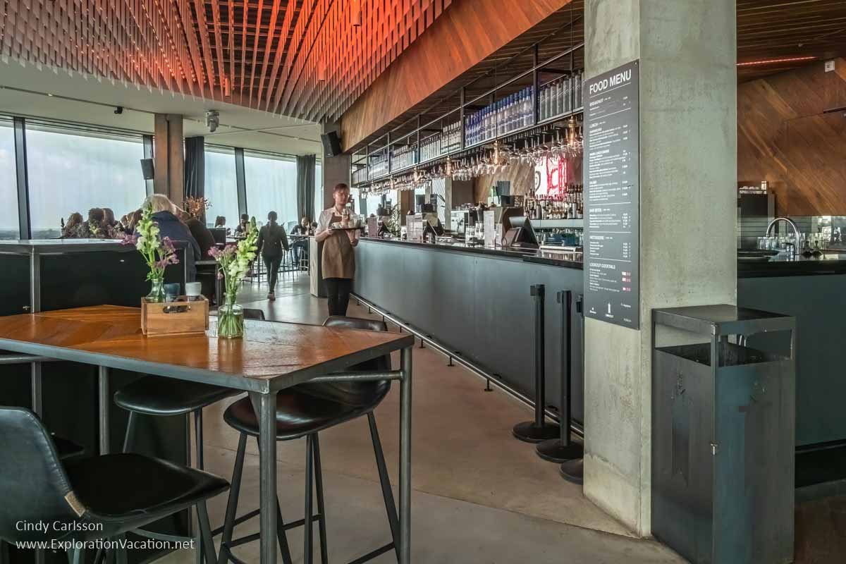 tables and bar with panoramic windows in background