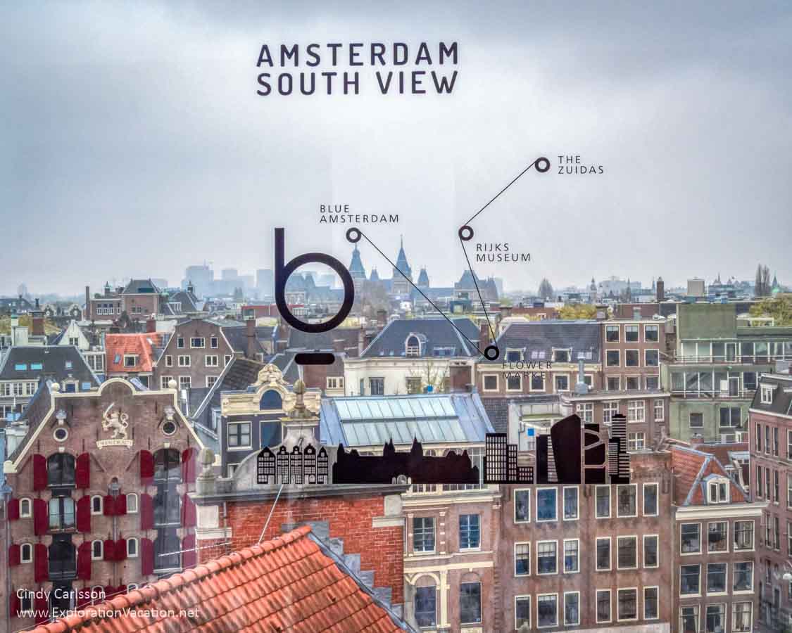 view out a window at the rooftops of Amsterdam with text