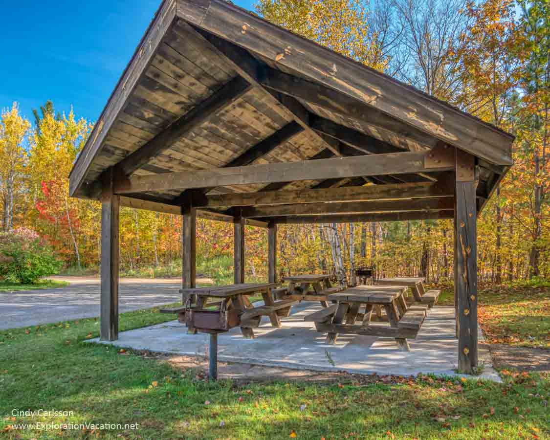 picnic tables under a wooden shelter