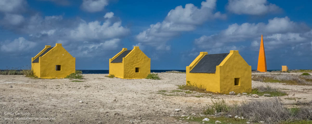 small yellow huts along the sea