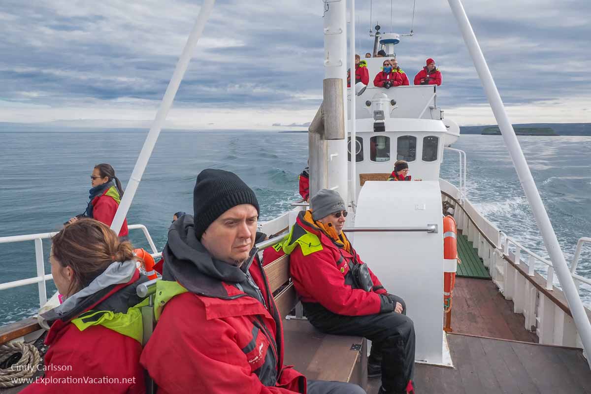 passengers in foul weather gear on a boat