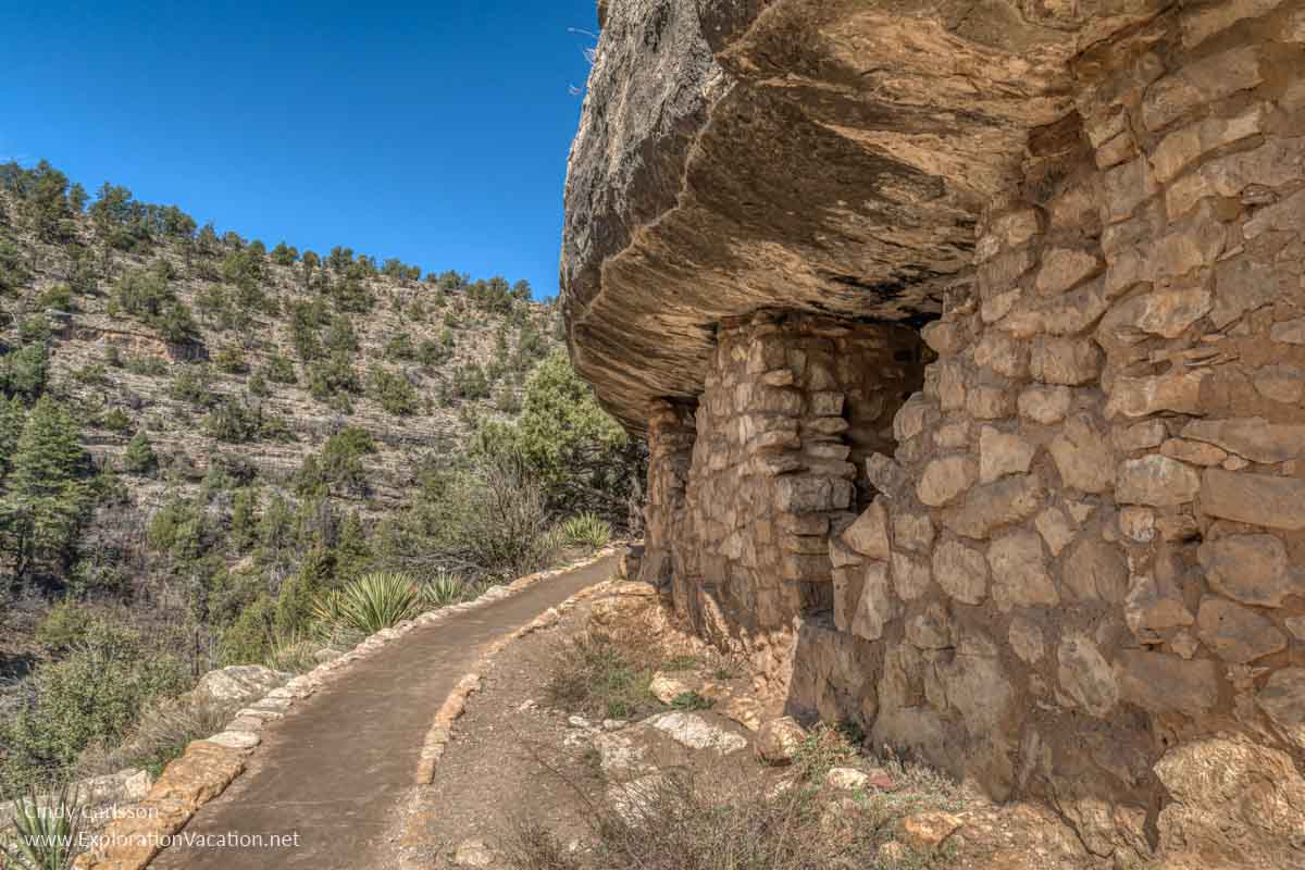 cliff dwelling along a paved path