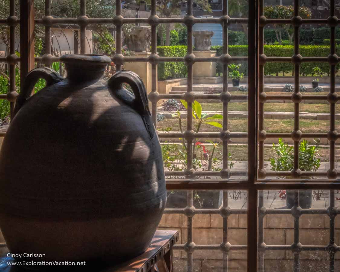 water jug by a screen with view of a garden in Cairo