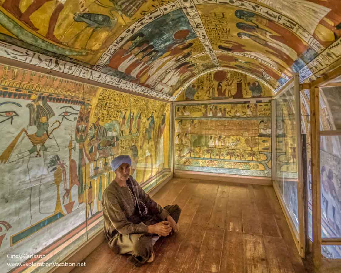 interior of a small tomb with a man sitting inside