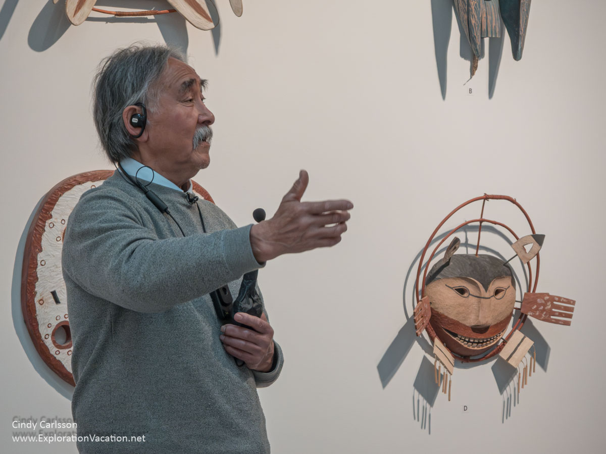 Abraham Anghik Ruben with his copies of traditional Arctic masks.