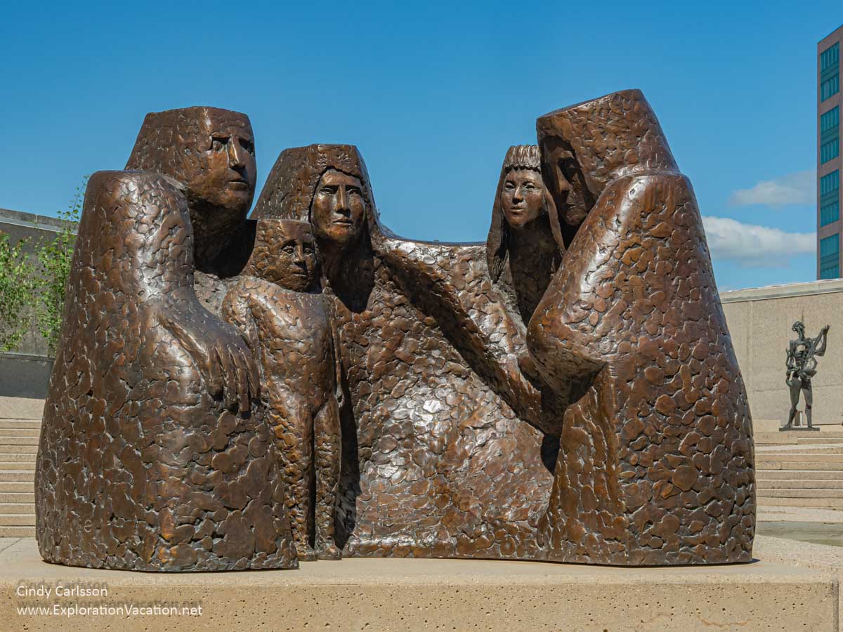 A large outdoor sculpture of stylized people by Eva Stubbs.