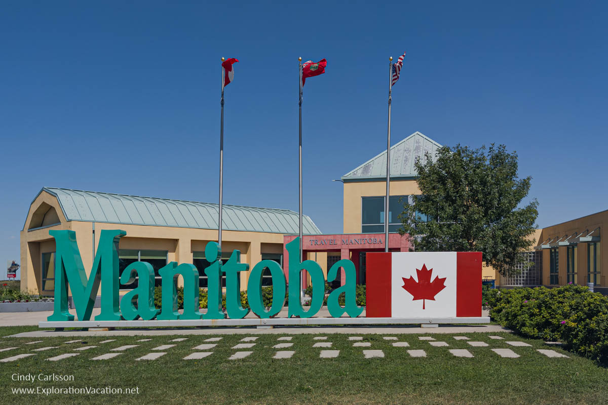 The Manitoba visitor center, with Manitoba in large letters by a large Canadian flag for selfie takers.
