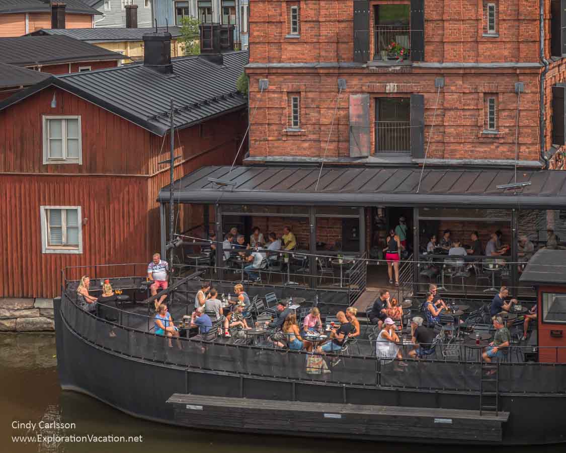 people eating on a boat used as a bar