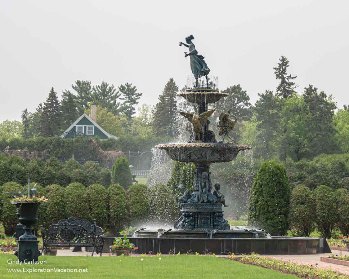 A tall fountain in a garden