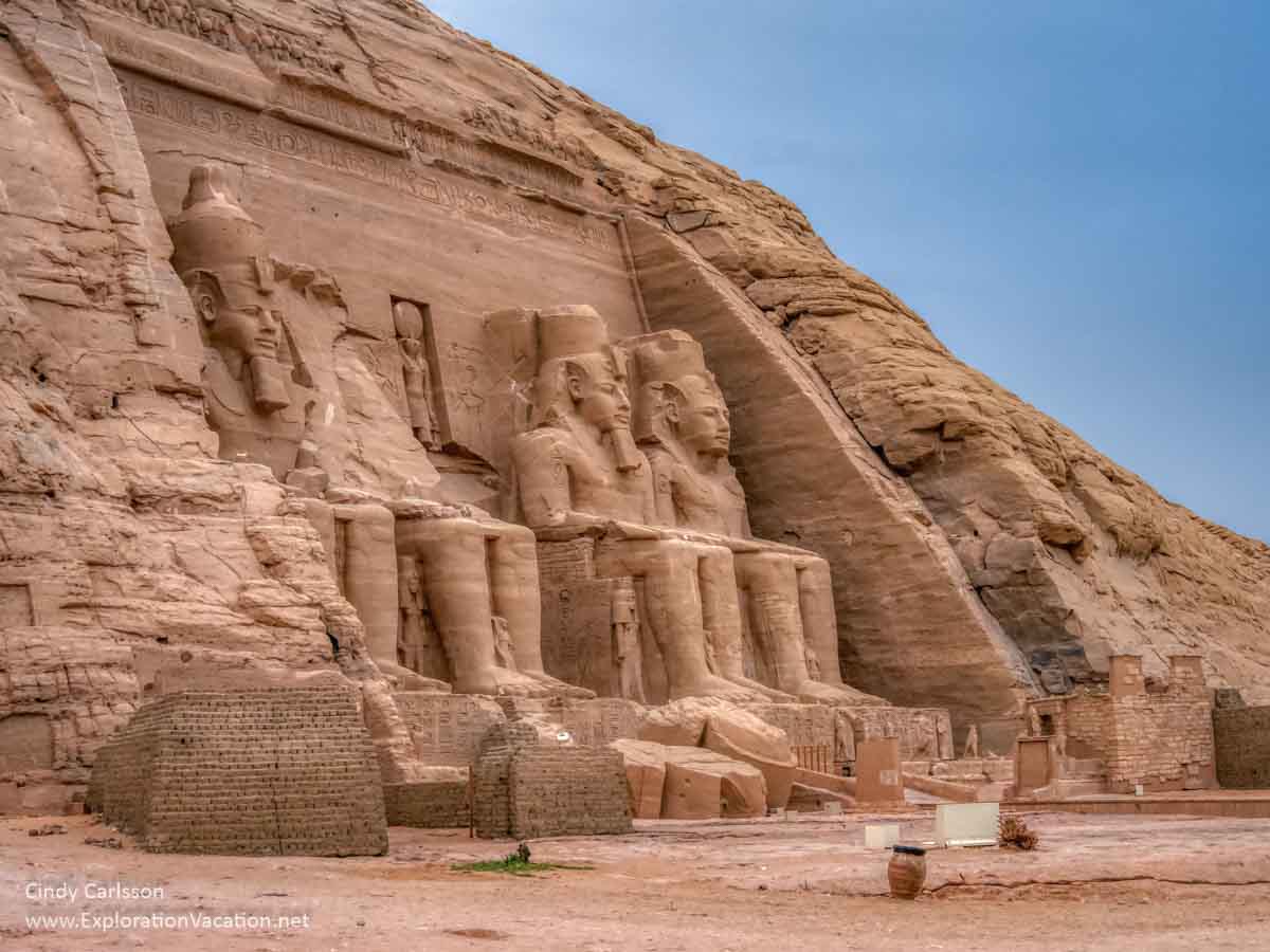 photo of monumental statues outside an Egyptian temple