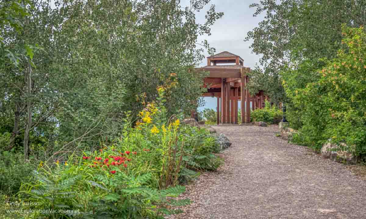 flower-lined path leading to a large gazebo