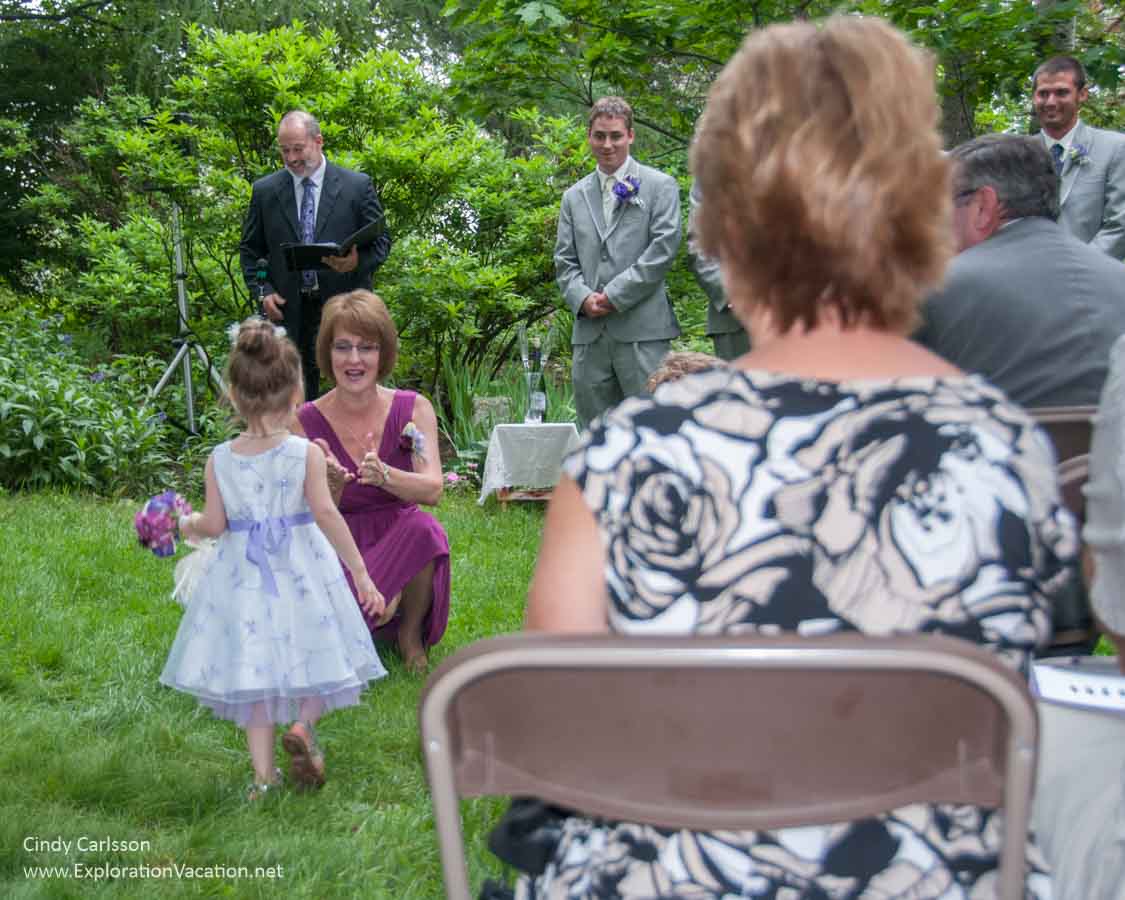 flower girl, wedding party, and a woman's back at a wedding in Duluth's Enger Park