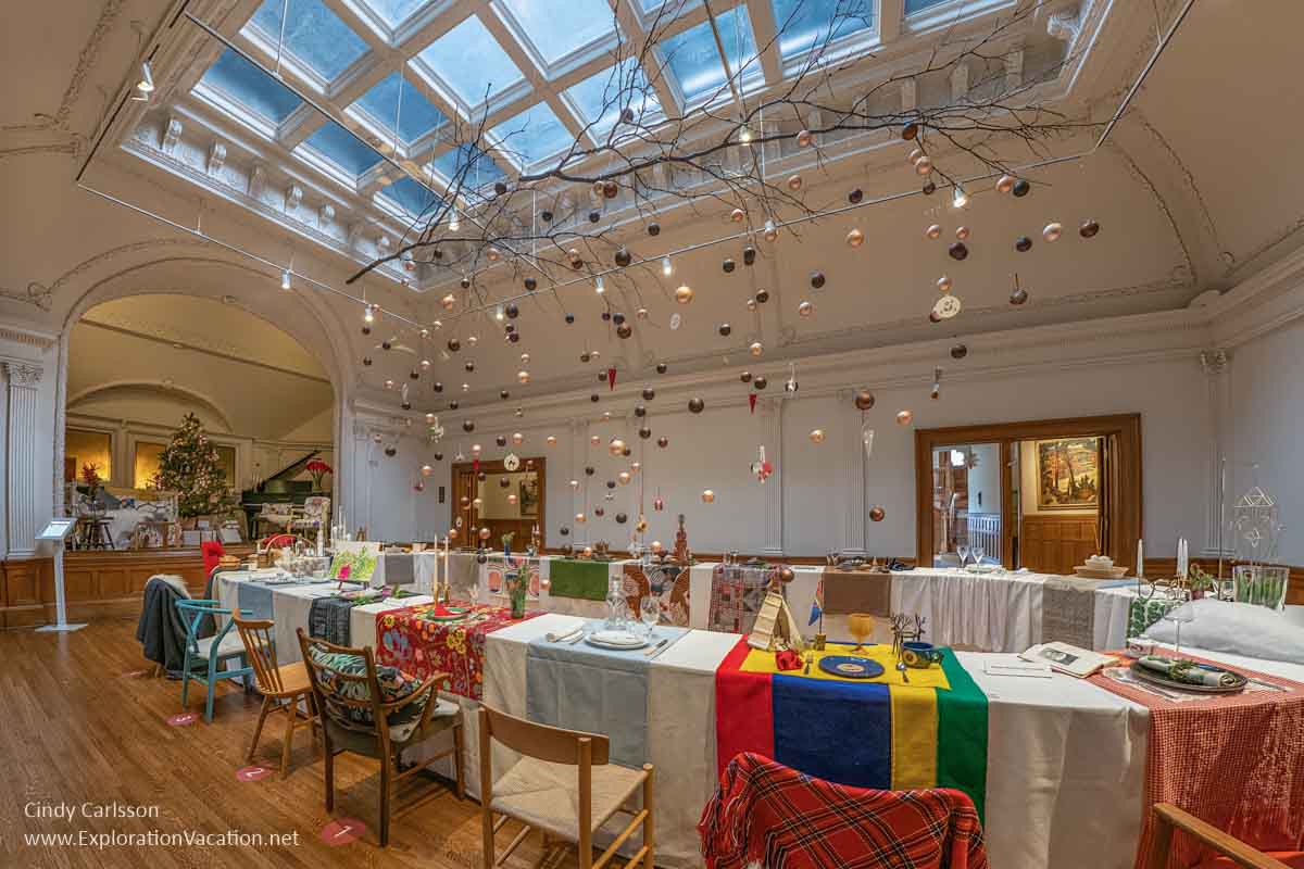 ballroom with large table set with Christmas place settings 