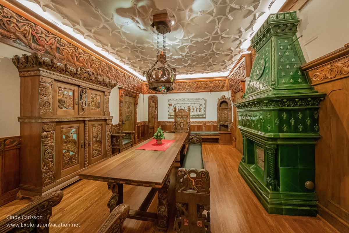 room decorated with heavily carved furniture depicting themes from Norse mythology
