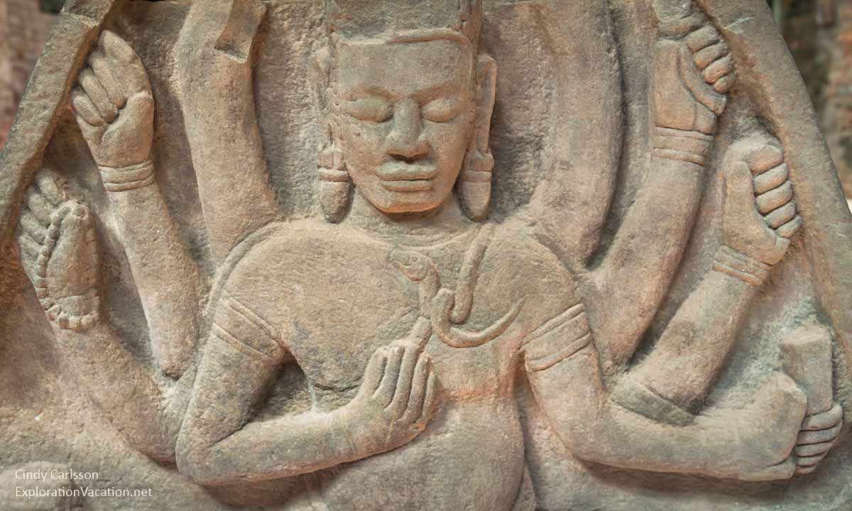 relief carving of Shiva with snake and multiple arms