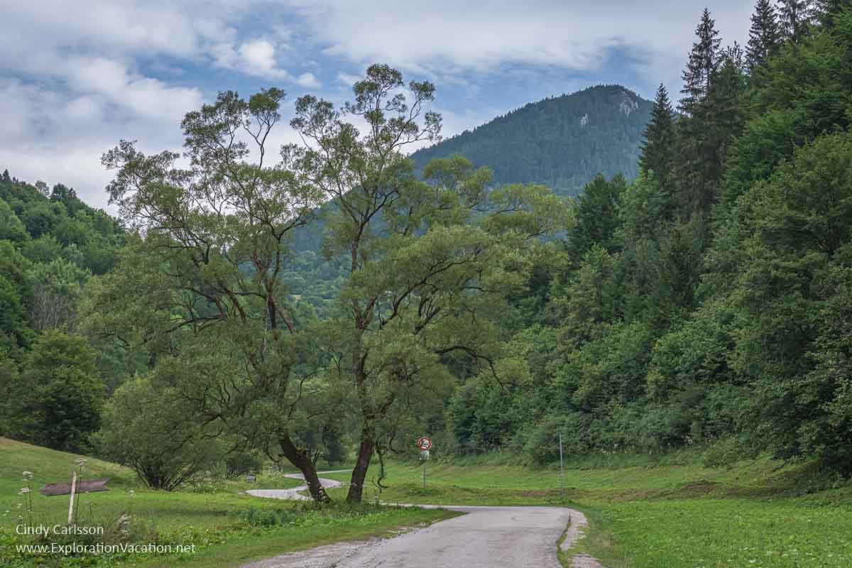 photo of narrow winding road through a mountain valley