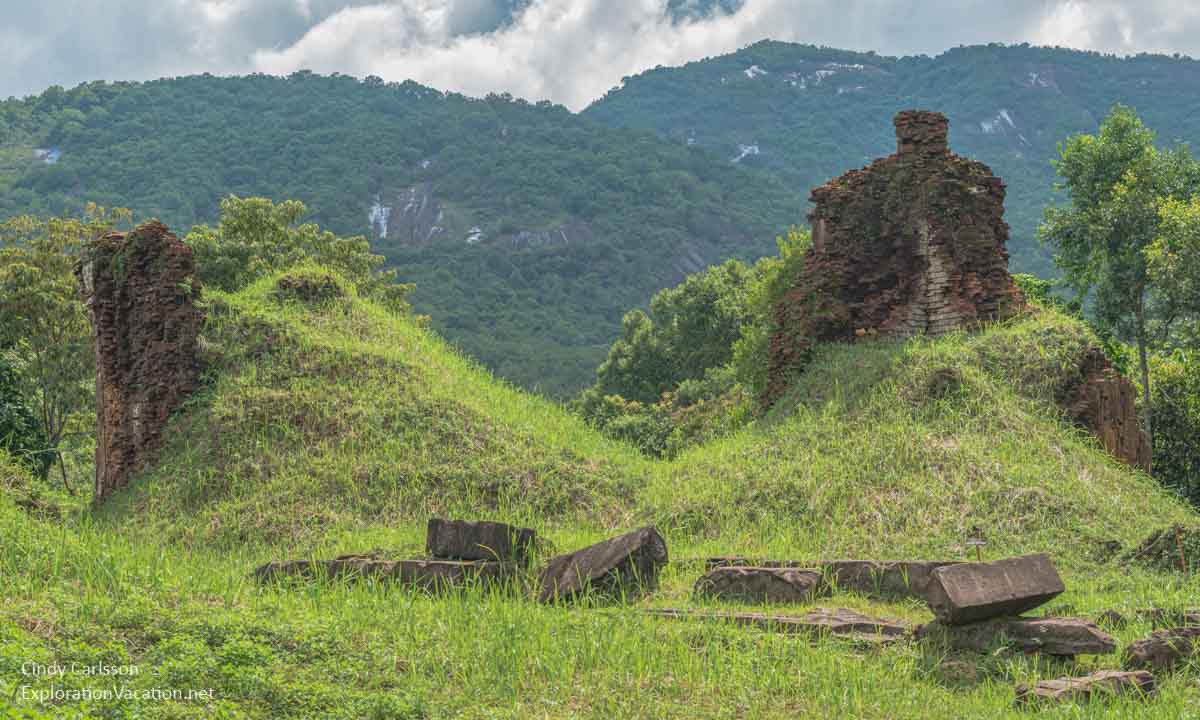 grass covered piles with ruins sticking out of the top