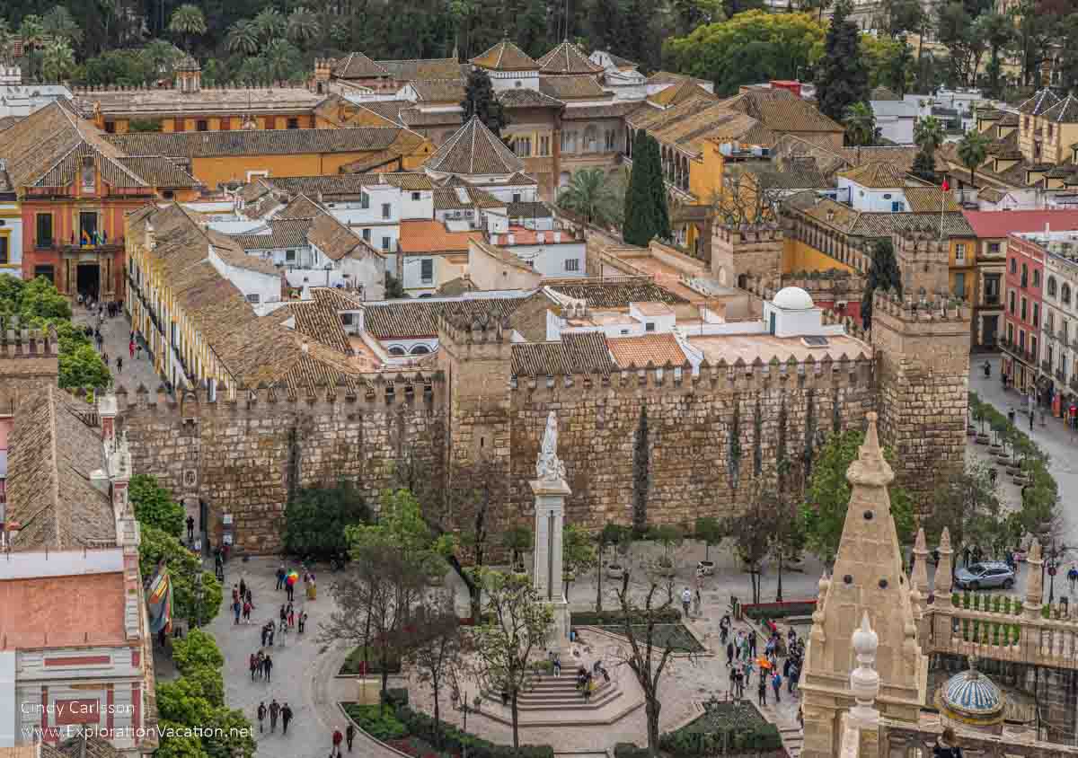 photo of the Alcazar palace and Columbus statue taken from up in the Giralda bell tower at Seville's Cathedral &copy;-Cindy Carlsson at ExplorationVacation