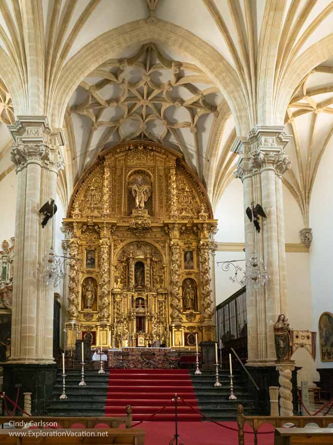 An elaborate golden altar within a marble arch in the Baeza, Spain, Cathedral.