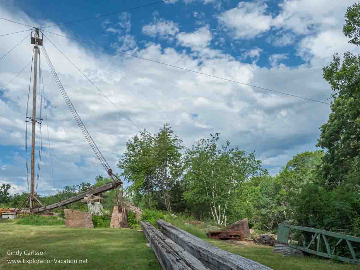 Photo of an old-fashioned wood derrick used to remove granite from a quarry on display at Quarry Park and Nature Preserve near St Cloud Minnesota. Text and photos © Cindy Carlsson ExplorationVacation.net