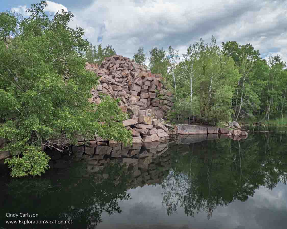 Photo of a water-filled quarry pit. Quarry Park and Nature Preserve near St Cloud Minnesota offers peaceful fishing holes in old stone quarries. Text and photos © Cindy Carlsson ExplorationVacation.net