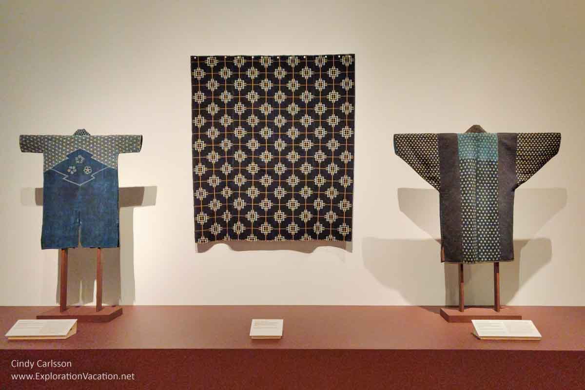Photo of indigo textiles, including an early 20th century boy’s uniform for swordsman practice and a late 19th - early 20th century Japanese farmer’s winter coat, on display in Dressed by Nature: Textiles of Japan at the Minneapolis Institute of Arts (Mia) in Minnesota © Cindy Carlsson - ExplorationVacation.net