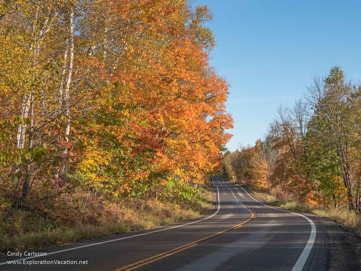 photo of road and trees with fall colors on Minnesota Highway 38, the Edge of the Wilderness National Scenic Byway © Cindy Carlsson at ExplorationVacation.net