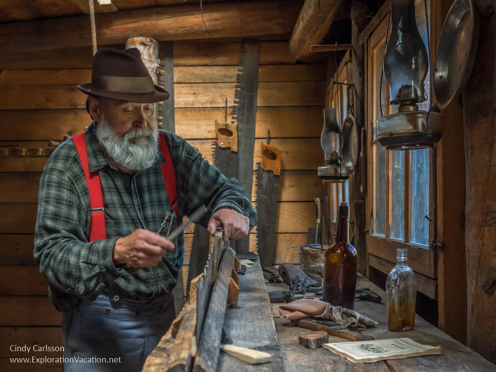 photo of a man dressed in old-fashioned clothes sharpening a hand saw at the Forest History Center in Grand Rapids Minnesota © Cindy Carlsson at ExplorationVacation.net