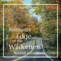 photo of a road surrounded by trees with brightly-colored leaves and text "Minnesota's Edge of the Wilderness National Scenic Byway - ExplorationVacation.net"