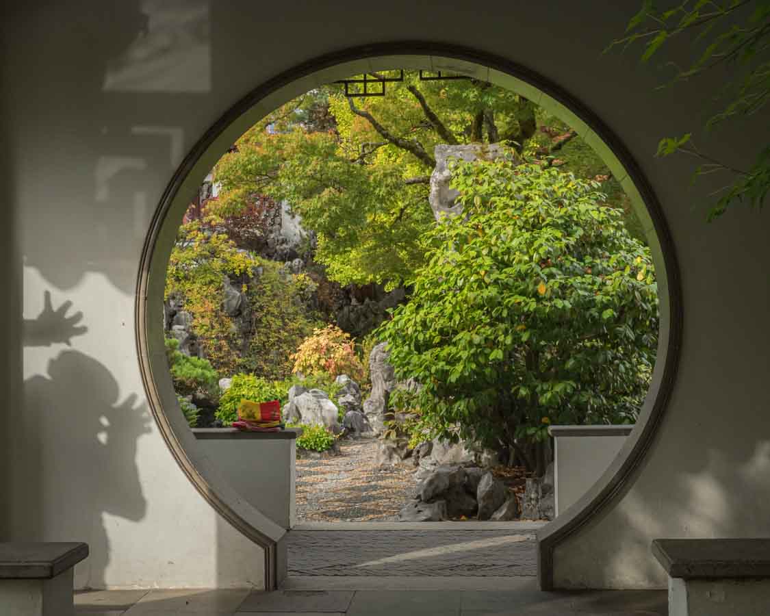 photo inside Dr. Sun Yat-Sen Classical Chinese Garden in Vancouver, Canada with the shadow of a person making faces © Cindy Carlsson at ExplorationVacation.net