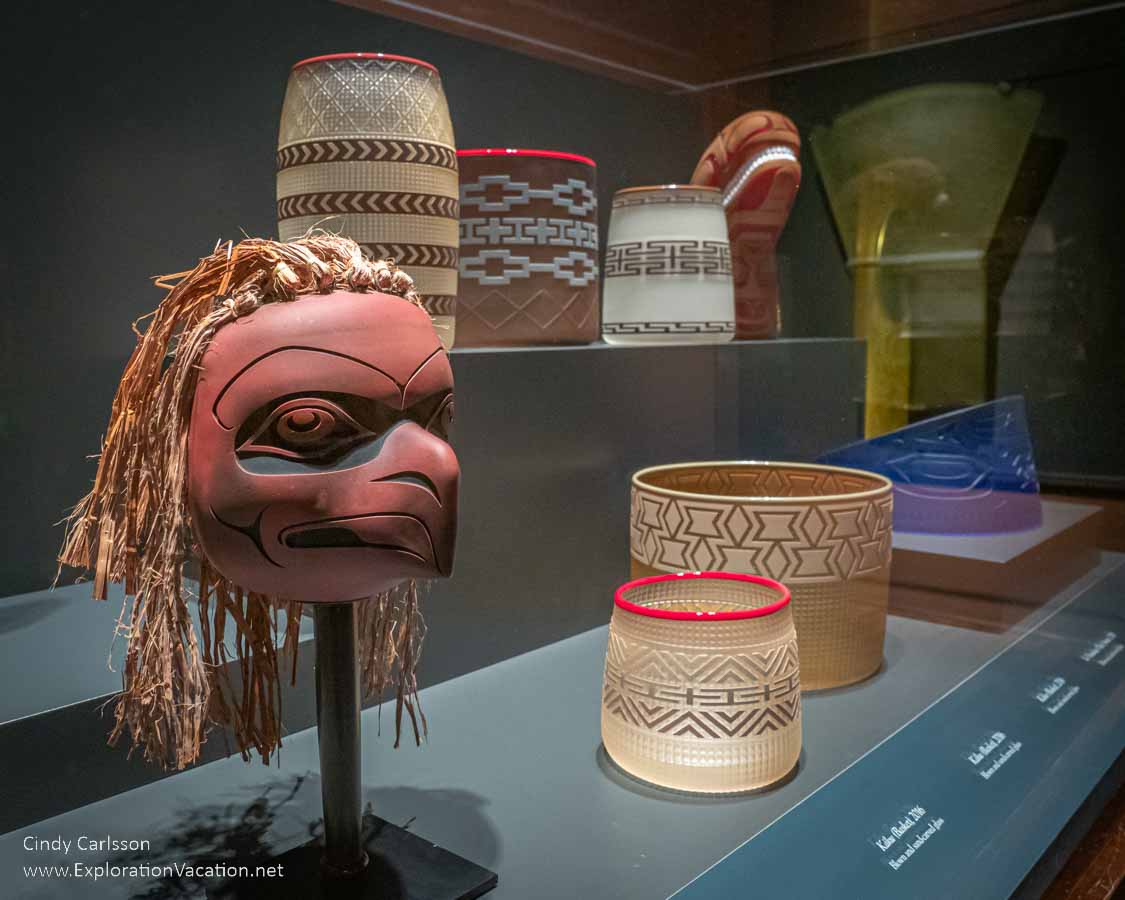 photo of Eagle rattle, baskets, and other items made from blown, hot-sculpted, and sand-carved glass by Tlingit artist Preston Singletary for "Raven and the Box of Daylight" at the National Museum of the American Indian Washington DC © Cindy Carlsson at ExplorationVacation.net
