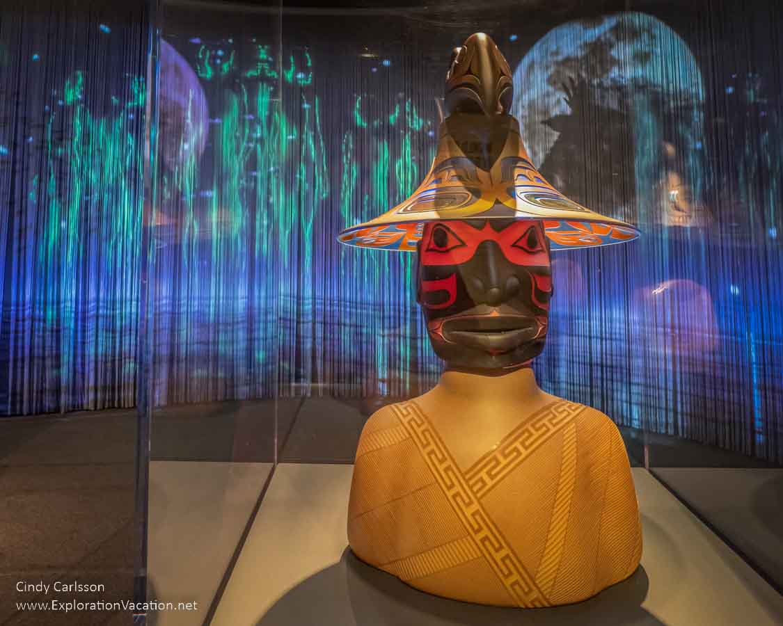 photo of a glass bust of a Tlingit Thunderbird Man by artist Preston Singletary for "Raven and the Box of Daylight" at the National Museum of the American Indian Washington DC © Cindy Carlsson at ExplorationVacation.net