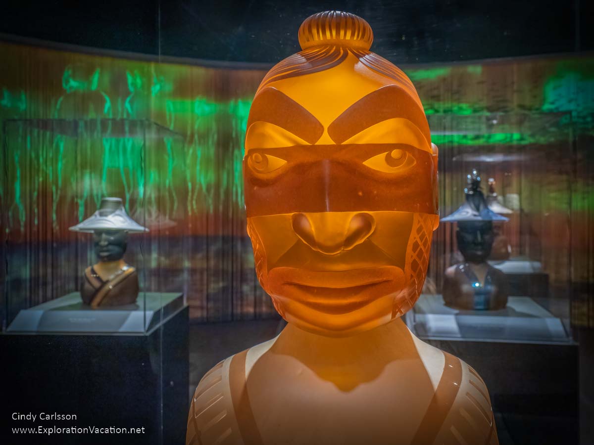 photo of a glass bust of a Tlingit warrior by artist Preston Singletary for "Raven and the Box of Daylight" at the National Museum of the American Indian Washington DC © Cindy Carlsson at ExplorationVacation.net