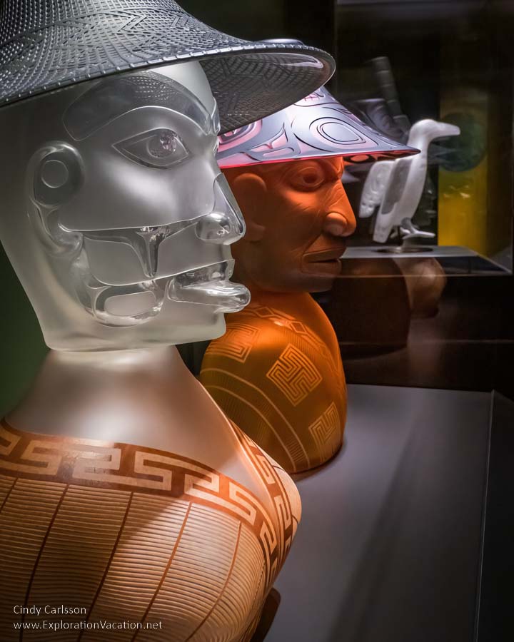 photo of two carved glass busts by Tlingit artist Preston Singletary for "Raven and the Box of Daylight" at the National Museum of the American Indian Washington DC © Cindy Carlsson at ExplorationVacation.net