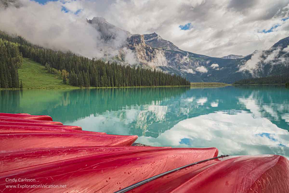 photo of canoes along the shore of Emerald Lake in Yoho National Park, part of the Canadian Rocky Mountain Parks UNESCO World Heritage Site © Cindy Carlsson at ExplorationVacation.net