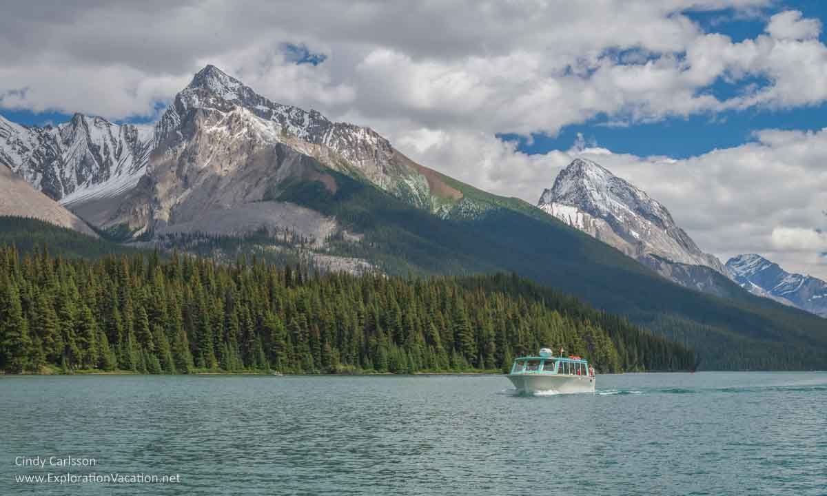 photo of a tour boat on Lake Maligne in Jasper National Park, part of the Canadian Rocky Mountain Parks UNESCO World Heritage Site © Cindy Carlsson at ExplorationVacation.net