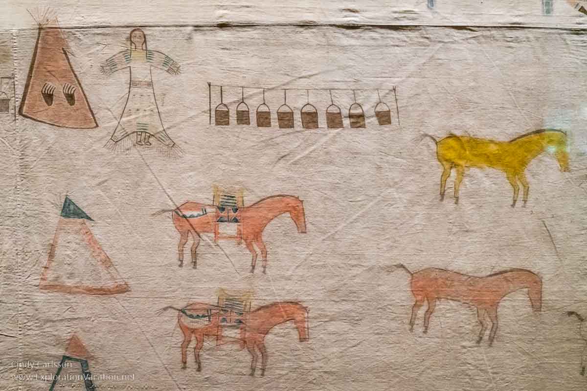 photo of a portion of a historic painting on cloth by Strike the Kettle depicting traditional Lakota life on display at the National Musuem of the American Indian in Washington DC © Cindy Carlsson at ExplorationVacation.net