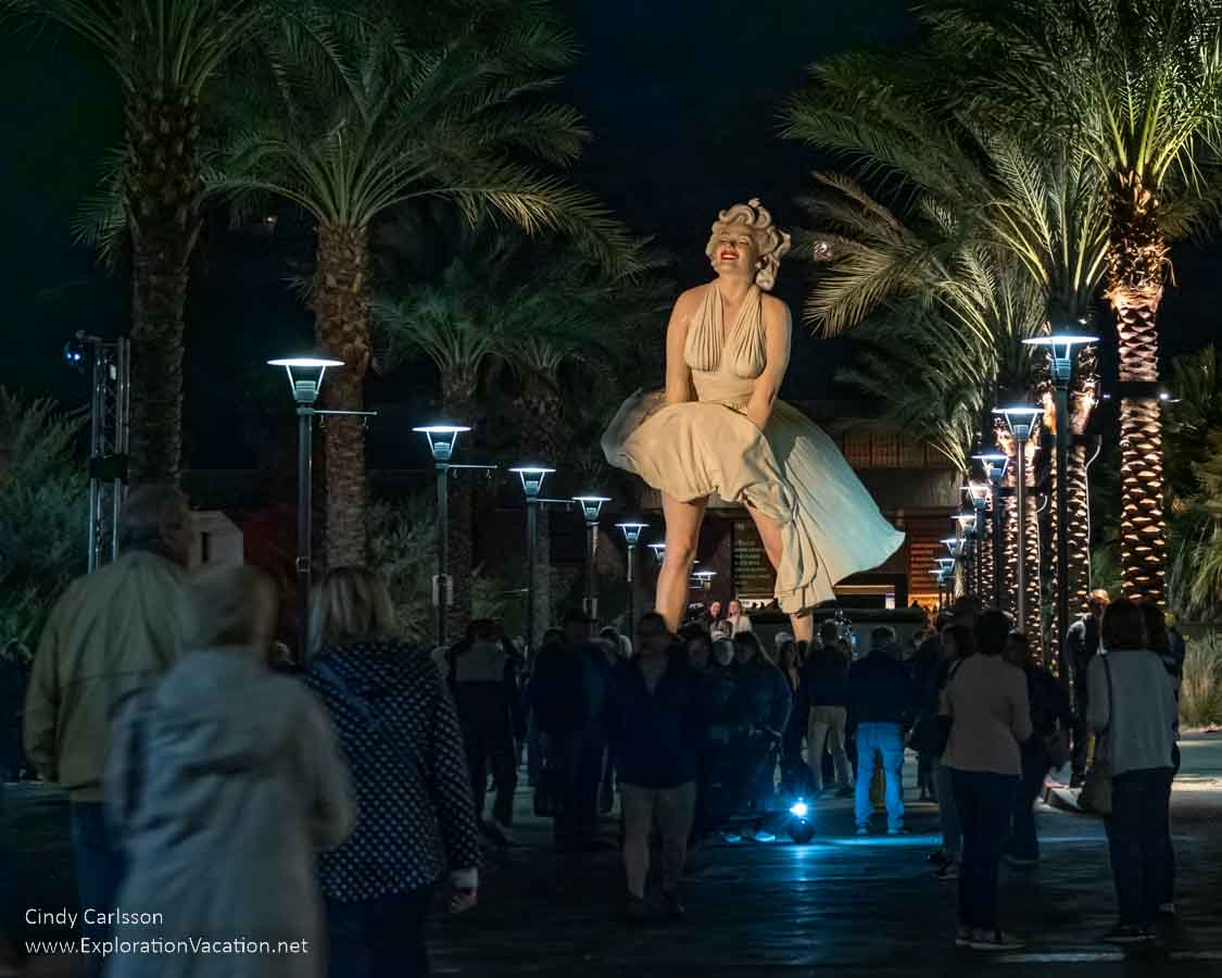 Photo of a very large statue of Marilyn Monroe by Seward Johnson towers over crowds moving between the evening Village Fest and the Palm Springs Art Museum in Palm Springs, California. (Photo &copy; Cindy Carlsson at ExplorationVacation.net)