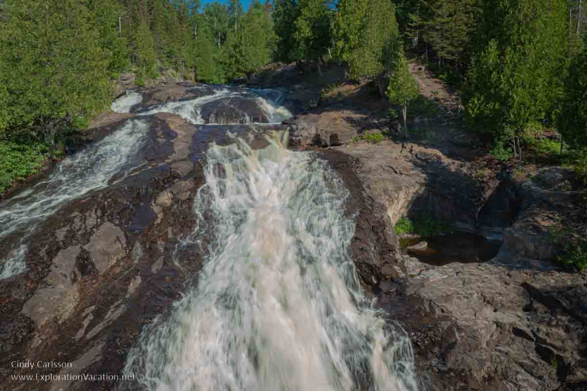 photo of the waterfall on the Cross River just before it goes under the highway bridge along Lake Superior's North Shore in Minnesota &copy; Cindy Carlsson at ExplorationVacation.net